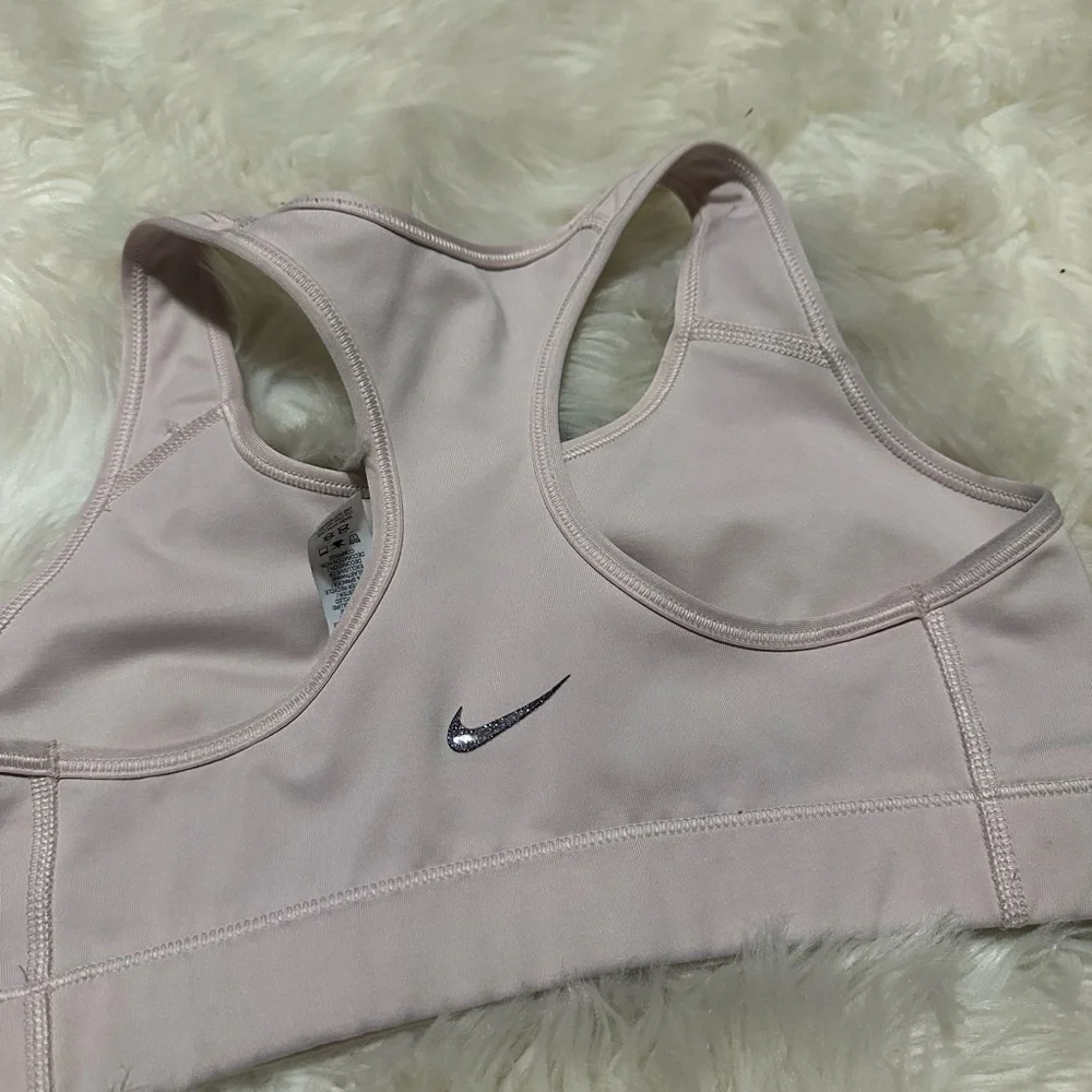 Nike Women's Light Pink Sports Bra with glitter logo. Has tiny stitch pictured!